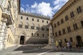 Monte dei Paschi di Siena bank, Palazzo Salimbeni with a statue of Sallustio Bandini, Siena, Tuscany, Italy Royalty Free Stock Photo