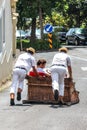 Monte, Madeira, Portugal - Sep 14, 2019: Wicker Basket Sledge ride with Carreiros do Monte. Traditional mean of transport to