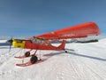 Monte Pora, Bergamo, Italy. A single engined, general aviation red light aircraft parked on a snow covered plateau