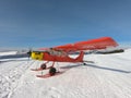 Monte Pora, Bergamo, Italy. A single engined, general aviation red light aircraft parked on a snow covered plateau