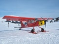 Monte Pora, Bergamo, Italy. A single engined, general aviation red light aircraft parked on a snow covered plateau