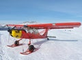 Monte Pora, Bergamo, Italy. A single engined, general aviation red light aircraft parked on a snow covered plateau