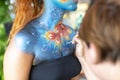 Montefiorino Modena, Italy : 2015 05 01 queen's day public event face painting portrait on model brunette face
