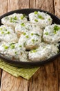 Montenegrin cuisine Kuvana Krtola boiled potatoes with curd yoghurt sauce close-up in a bowl. vertical