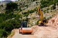 Montenegro, Cetinje - June, 29, 2017:Asphalt paver and excavator on a mountain road