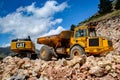 Montenegro, Cetinje - June, 29, 2017: Dumper with excavator on a stone mountain road