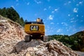 Montenegro, Cetinje - June, 29, 2017:Excavator CAT on a stone mountain road