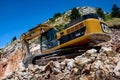 Montenegro, Cetinje - June, 29, 2017:Excavator CAT on a stone mountain road