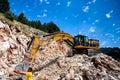Montenegro, Cetinje - June, 29, 2017:Excavator CAT works on a stone mountain road
