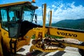 Montenegro, Cetinje - June, 29, 2017: Motor graders from Volvo Construction Equipments on a mountain road