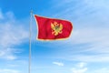 Montenegro flag over blue sky background