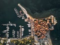 Montenegro. The old town of Budva. The view from the top. Orange roofs of the old town. The port of Budva.