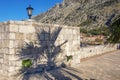 Montenegro, Old Town of Kotor, detail. Part of ancient Town Wall with street light and shadow of palm tree