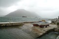 Montenegro port, wavy sea and foggy weather. Small boat taken ashore Royalty Free Stock Photo