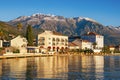 Sunny winter in Montenegro. Embankment of Tivat city and snow-capped peaks of Lovcen mountain Royalty Free Stock Photo