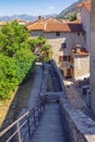 Montenegro. View of Old Town of Kotor. Staircase of ancient fortifications, red roofs and street of Old Town