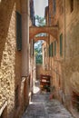 Narrow alley with medieval houses and wine shop in Montepulciano, Tuscany, Italy Royalty Free Stock Photo