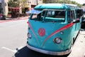 Monterey, CA, USA - 18 Aug 2022: Close up of the front of an eye-catching bright blue and pink VW mini bus.