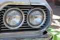 Monterey, CA, USA - 18 Aug 2022: Macro, twin headlamps on an antique Chevrolet during Classic Car Week.