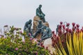 Bronze statue, a monument on Cannery Row pays tribute to John Steinbeck, friends and to Monterey`s unique history, Monterey, CA