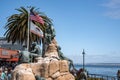 Cannery Row Monument with flags of America and California at coastline
