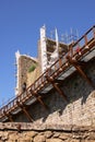 The walls of the Monteriggioni fortress under repair.