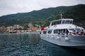 Passenger ferry boat with tourists on board is moored in bay of Mediterranean Sea Royalty Free Stock Photo