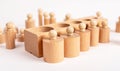 Montessori knobbed wooden cylinders with block. Kids puzzle for comparison, grading and seriation development