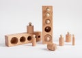 Montessori knobbed wooden cylinders with blocks. Puzzle for teaching child to distinguish small differences in size