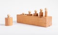 Montessori knobbed wooden cylinders incorrectly placed in block. Error in puzzle assembly. Kids game for development of