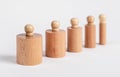 Montessori knobbed wooden cylinders row of different size from thick to thin. Children game