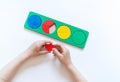 Montessori material. Children`s hands. Whole and part. Fractions. The study of mathematics