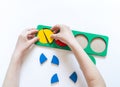 Montessori material. Children`s hands. Whole and part. Fractions. The study of mathematics