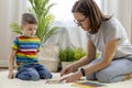 Montessori material. Colored movable alphabet made of wood on a blackboard. Baby boy