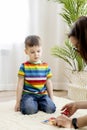 Montessori material. Colored movable alphabet made of wood on a blackboard. Baby boy