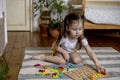 Montessori material. Colored movable alphabet made of wood on a board tray. Child toddler girl