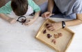 Montessori material. Schoolboy plays doctor at home. Flat lay