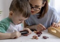 Montessori material. Schoolboy plays doctor at home