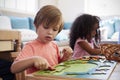 Montessori Pupil Working At Desk With Wooden Shapes Royalty Free Stock Photo