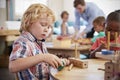 Montessori Pupil Working At Desk With Wooden Shapes Royalty Free Stock Photo