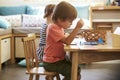 Montessori Pupil Working At Desk With Wooden Shapes Royalty Free Stock Photo