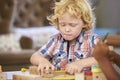 Montessori Pupil Working At Desk With Wooden Shapes Royalty Free Stock Photo