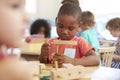 Montessori Pupil Working At Desk With Wooden Shapes Royalty Free Stock Photo