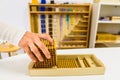 Montessori student hands using sensory materials in a school