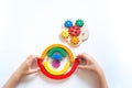 Montessori wood rainbow material. A child plays with a toy with his hands