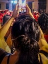 Girl taking photos at call parade carnival, montevideo, uruguay