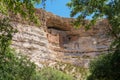 Montezuma\'s castle cliff dwelling in Camp Verde, viewed through tree branches