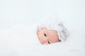 0-1 month Asian newborn baby lie down on white fur background or soft blanket, toddler infant open eye after long sleeping, baby Royalty Free Stock Photo