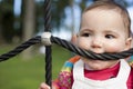 11 month baby girl bitting playground rope as it was a teether