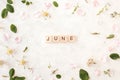 Month of june - white background with rose petals and leaves. Spring floral background